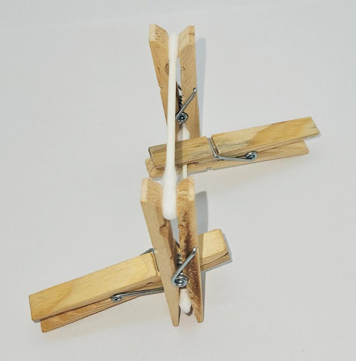 STEM for kids shows clothes pins and cotton swabs.