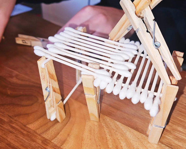 easy STEM challenge for kids shows a structure made from cotton swabs and clothes pins.